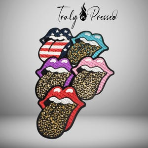 May include: A collection of embroidered patches in the shape of a tongue and lips. The patches feature various designs, including the American flag, leopard print, and solid colors. The text "Truly in Pressed" is at the top.