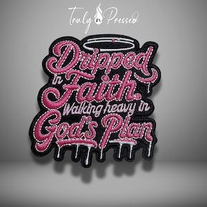 May include: Black patch with pink embroidered text that reads "Dripped in Faith, Walking heavy in God's Plan." The patch has a white border and a halo design at the top. The words have a dripping effect.