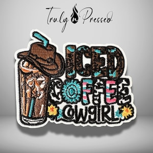 May include: An embroidered patch featuring a brown cowboy hat resting on a glass of iced coffee with a turquoise straw. The text reads ICED COFFEE COWGIRL in black, brown, turquoise, and pink letters, accented with small yellow flowers.