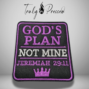 May include: A rectangular black embroidered patch with a purple border. The text reads GOD'S PLAN in purple, NOT MINE in white, and JEREMIAH 29:11 in purple. A purple crown icon is at the bottom. The text Truly n Pressed is visible above the patch.