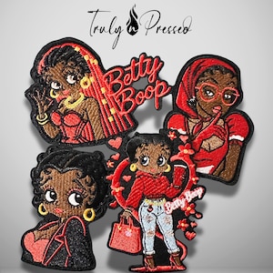 May include: Four embroidered patches featuring Betty Boop in various outfits and poses, with red and black color schemes. The text Truly Pressed is at the top, and the name Betty Boop appears in red script on two of the patches.