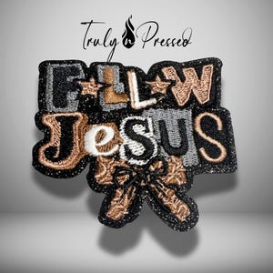 May include: Embroidered patch with the words "FOLLOW JESUS" in black, gold, silver, and white. The patch includes a cross design and the text "Truly Pressed" in script.