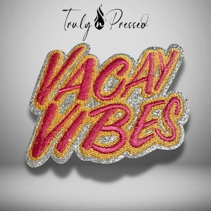 May include: Embroidered patch with the words "VACAY VIBES" in a cursive font. The letters are pink with a gold outline and a silver glitter border. The patch has the text "Truly Pressed" at the top.