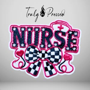 May include: An embroidered patch featuring the word NURSE in dark blue letters with white star accents, outlined in bright pink. Below the text is a black and white checkered bow, flanked by two pink hearts connected by pink lines.