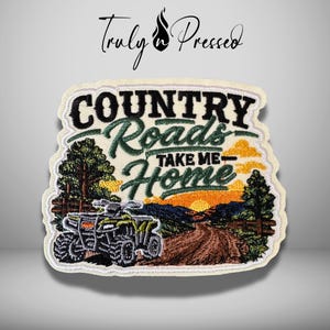 May include: An embroidered patch featuring a green ATV on a dirt path with pine trees and a sunset background. The text reads "COUNTRY ROADS TAKE ME HOME" in black and green lettering. The patch has a cream-colored border and a white background.