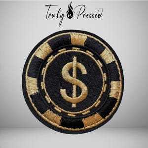 May include: A circular embroidered patch featuring a black and gold poker chip design. The center displays a prominent gold dollar sign symbol. The border consists of alternating black and gold rectangular segments, mimicking the edge of a chip.