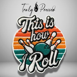May include: A circular embroidered patch featuring a retro sunset background with orange, yellow, and teal stripes. The design includes a teal bowling ball, white bowling pins, and the black embroidered text "This is how I Roll".
