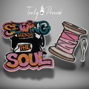 May include: Two embroidered patches: one with the text "Sewing Mends the Soul" and a sewing machine graphic, the other a spool of pink thread with a needle. The patches have a white border and are on a gray background.