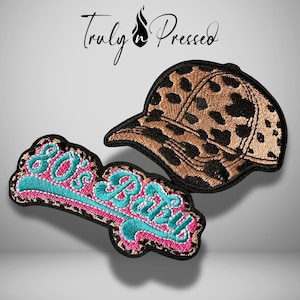 May include: Embroidered patches featuring a leopard print baseball cap and a pink and teal "80's Baby" design. The patches have a black border and are set against a light gray background. The brand name "Truly Pressed" is at the top.