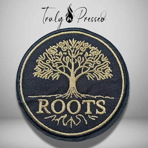 May include: A circular embroidered patch featuring a black background with a gold stitched tree of life design. The word ROOTS is embroidered in gold capital letters below the tree. The text Truly n Pressed appears above the patch.