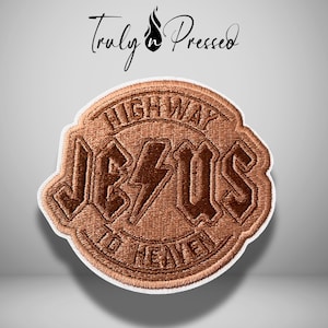 May include: A circular embroidered patch featuring a copper-colored thread design. The text reads HIGHWAY TO HEAVEN with JESUS in the center, where the letter S is replaced by a lightning bolt. The brand name Truly n Pressed is above the patch.