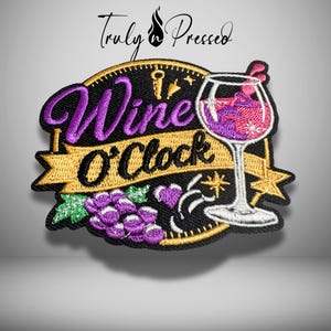 May include: An embroidered patch featuring a black circular background with gold trim. It displays a wine glass filled with purple liquid, a cluster of purple grapes with green leaves, and a gold banner with the black text Wine O'Clock.