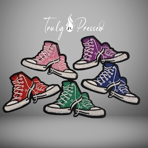 May include: Embroidered patches of high-top sneakers in various colors: pink, purple, blue, green, and red. Each patch has white laces and a white sole. The text "Truly n Pressed" is in the upper center.