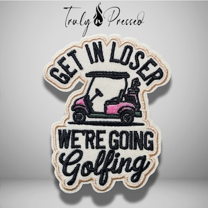 May include: An embroidered patch featuring a pink and black golf cart graphic centered between the black text GET IN LOSER and WE'RE GOING GOLFING. The patch has a white background with a tan border and a scalloped edge, showcasing detailed stitching.
