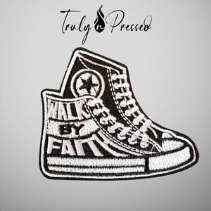 May include: An embroidered patch shaped like a high-top sneaker in black and white thread. The design features a star logo on the ankle and the text "WALK BY FAITH" on the side. Above the sneaker, the text "Truly n Pressed" is displayed.