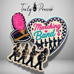 May include: Three embroidered patches featuring a black marching band hat with a bright pink plume, a heart-shaped patch with the text "Marching Band" in pink and blue, and a patch showing four black silhouettes of musicians playing instruments.