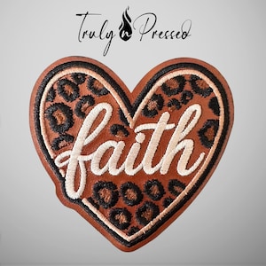 May include: A heart-shaped patch featuring a brown and black leopard print pattern with the word faith embroidered in white script across the center. The text Truly n Pressed is positioned above the heart in a black cursive font.