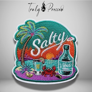 May include: A circular embroidered patch featuring a tropical beach scene with a palm tree, a crab, a shot glass, and a bottle labeled 'Vibes'. The text 'Salty' is stitched in white across the center. The design includes orange, teal, and purple colors.