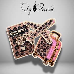 May include: Three embroidered patches featuring a brown and black leopard print design. One patch is a rectangular passport with the word PASSPORT, a globe icon, and a heart. Another is an airplane, and the third is a pink rolling suitcase.