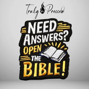 May include: A black embroidered patch featuring the white text "NEED ANSWERS?" and yellow text "OPEN THE BIBLE!" with an illustration of an open book. The design includes yellow horizontal lines and a small flame icon above the text.