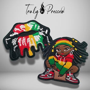May include: Two embroidered patches featuring a black border. One patch depicts lips with red, yellow, and green paint drips. The other patch shows a character with dreadlocks wearing a red, yellow, and green hoodie and red and white sneakers.