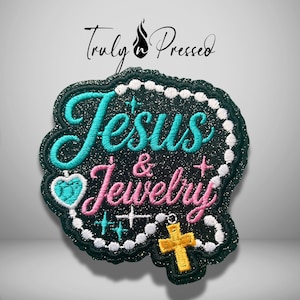 May include: A black glittery embroidered patch featuring the text Jesus in teal and Jewelry in pink. A white beaded rosary chain frames the text, accented by a teal heart, a yellow cross, and small star-shaped sparkles. The text Truly n Pressed is above.