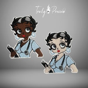 May include: Two embroidered patches featuring a cartoon nurse character with black hair, red lips, and light blue hoop earrings. Each character wears a light blue scrub top and a stethoscope, holding a black clipboard. The text Truly Pressed is visible.