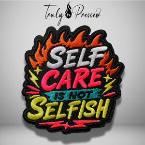 May include: An embroidered patch with a black background featuring the text "SELF CARE IS NOT SELFISH" in white, pink, teal, and yellow thread. The design is surrounded by orange and red flame motifs, yellow lightning bolts, and small stars.