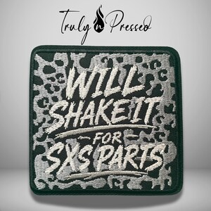 May include: A square embroidered patch featuring a black and silver leopard print background. The white embroidered text reads "WILL SHAKE IT FOR SXS PARTS" in a bold, stylized font. The patch has a dark green border and a black edge finish.