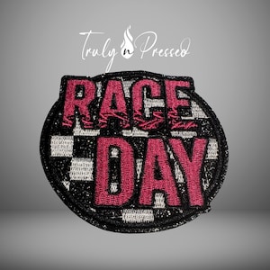 May include: A circular patch with the words "RACE DAY" in a bold, red font. The patch has a black border with glitter and a checkered flag design in black and white. The words "Truly n Pressed" are written in cursive at the top.
