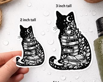May include: Black and white waterproof kiss-cut stickers featuring a cat silhouette filled with books, a teacup, and celestial elements. One sticker is 2 inches tall, the other is 3 inches tall.