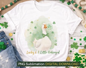 May include: White t-shirt featuring a watercolor illustration of a goose wearing a green bow tie, with a shamrock bubble. The text "Lucky & A Little Unhinged" is below the goose. The shirt is surrounded by shamrocks and coins.