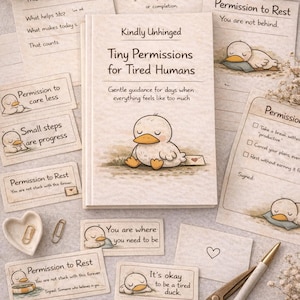 May include: A collection of stationery items, including a book titled "Tiny Permissions for Tired Humans," cards with duck illustrations, and a pen. The book and cards have a soft, neutral color palette with whimsical illustrations.