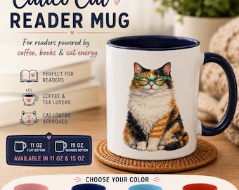 May include: A white ceramic mug with a dark blue interior and handle, featuring a calico cat wearing green glasses. Text reads: Calico Cat READER MUG, For readers powered by coffee, books & cat energy. Available in 11 oz and 15 oz sizes with color options.