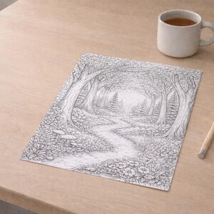 May include: Black and white forest path drawing with detailed trees, flowers, and mushrooms. A cup of tea, a small potted plant, and a pencil are on a light wood surface.