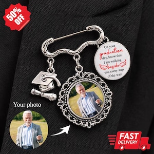 May include: Silver-toned graduation pin with a photo pendant and a mortarboard charm. The pin includes the text "On your graduation day, know that I am walking beside you every step of the way."