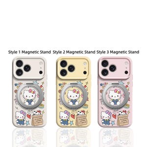 May include: Three phone cases with magnetic stands, each featuring a Hello Kitty design. The cases are in cream, yellow, and pink. Each case has a ring holder and a design with Hello Kitty, hearts, and text.