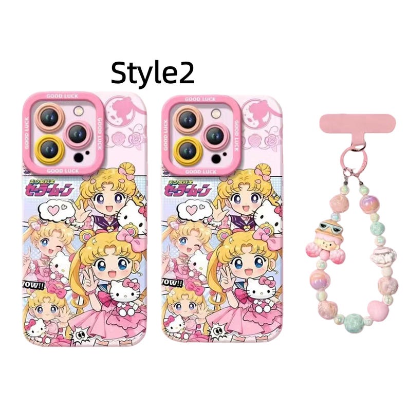 May include: Pink phone cases with a cartoon illustration of a blonde girl in a sailor suit and a Hello Kitty character. The cases have a pink camera lens protector with the words "GOOD LUCK". A matching beaded phone charm is also included.