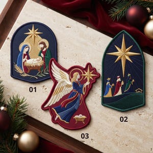 May include: Three embroidered patches featuring religious holiday scenes. Patch 01 shows a nativity scene with a gold star. Patch 02 is a pointed arch shape depicting three figures and a large gold star. Patch 03 is an angel holding a star.