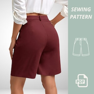 May include: Burgundy shorts with a high waist and button closure, viewed from the back. A white blouse is visible at the top. The image includes the text "SEWING PATTERN" and a PDF icon, indicating a sewing pattern.