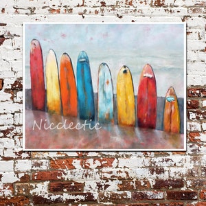 May include: A painting depicting seven colourful surfboards arranged on a beach. The surfboards are painted in shades of red, orange, yellow, blue, and green. The painting has a vintage, distressed appearance.