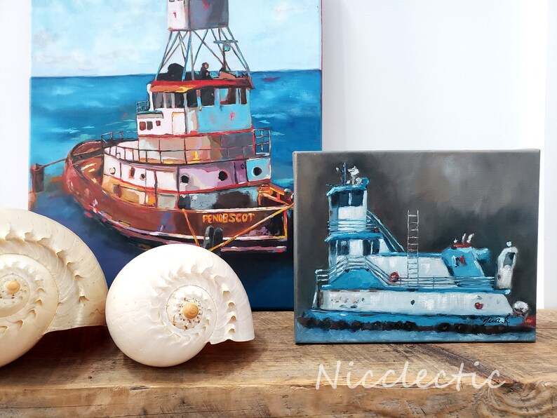 May include: Two paintings of tugboats on canvas. The larger painting shows a red, white, and blue tugboat with the name "Pendscot" on the side. The smaller painting shows a blue and white tugboat with a dark gray background.