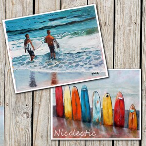 May include: A painting of two surfers standing on a beach with their surfboards. The painting is in a bright, colourful style with a blue sky and ocean. The painting is signed "Pink R".