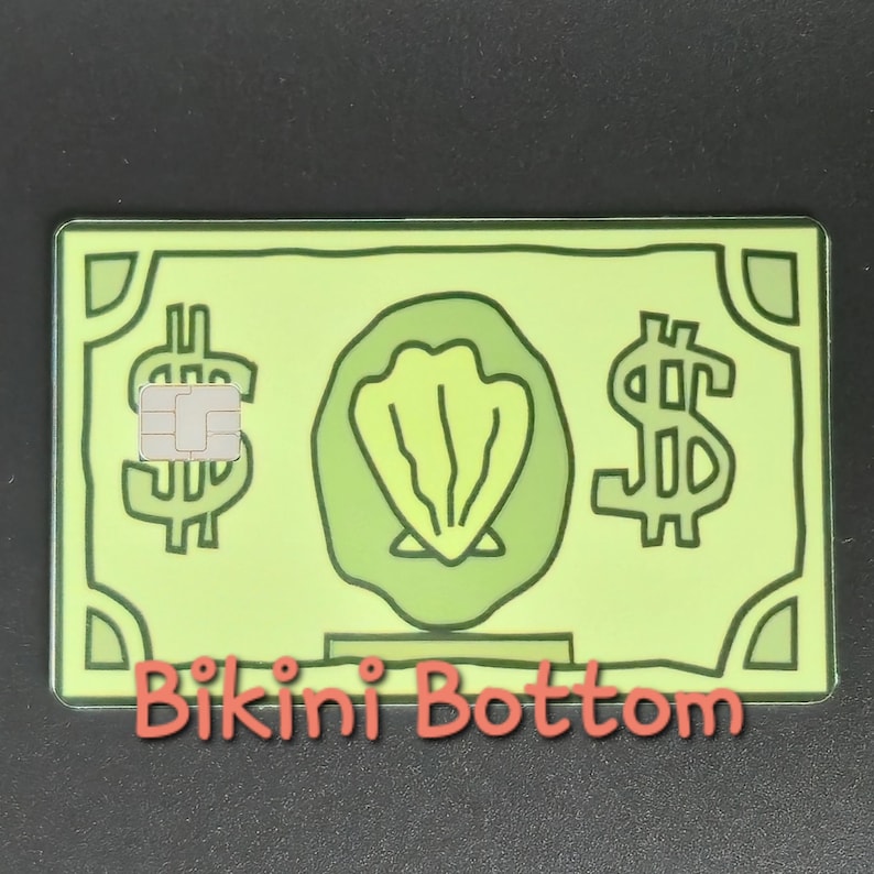 May include: A green credit card-shaped design with dollar signs and a seashell graphic. The card has a chip and the words "Bikini Bottom" in red. The overall design resembles a dollar bill.