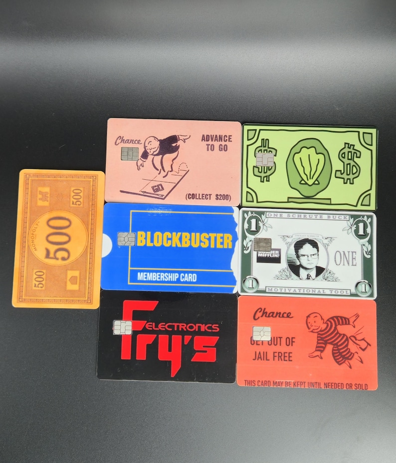 May include: A collection of novelty cards, including a $500 bill, a Blockbuster membership card, and cards with the Fry's Electronics logo. Other cards feature Monopoly-themed art and the text "Chance" and "Get Out of Jail Free."