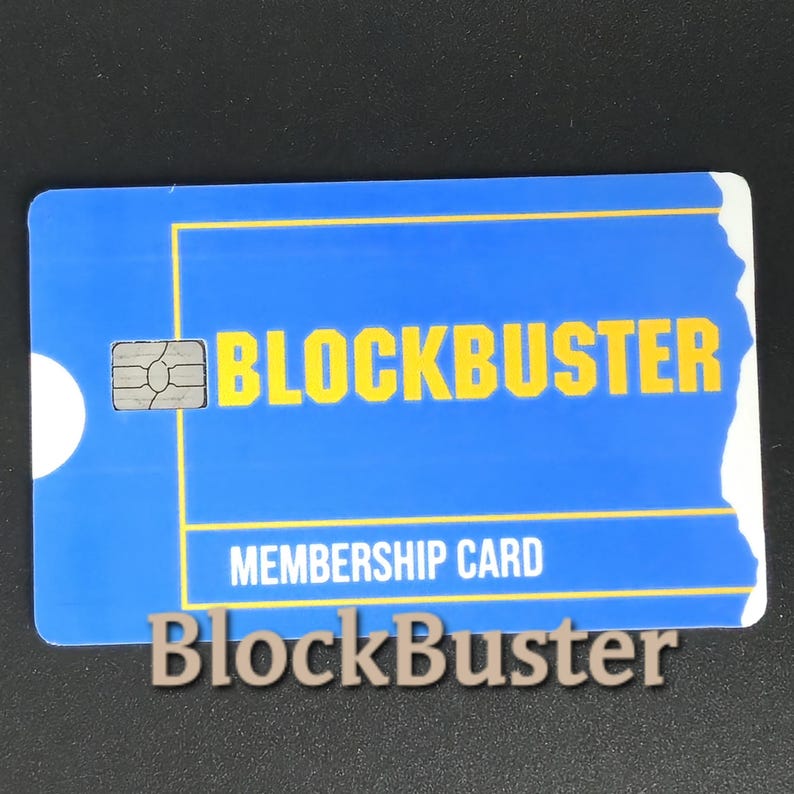 May include: A blue Blockbuster membership card with yellow text and a white circle on the left side. The card reads "BLOCKBUSTER" and "MEMBERSHIP CARD". A smaller Blockbuster logo is below the card.