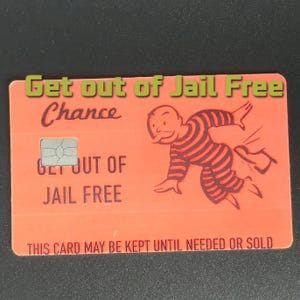 May include: An orange card with the text "Get out of Jail Free" and "Chance". It features a cartoon of a person in prison stripes running away. The card also has a chip and the text "THIS CARD MAY BE KEPT UNTIL NEEDED OR SOLD".