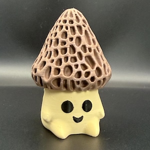 May include: A whimsical, 3D-printed mushroom figurine. The mushroom cap is a textured, brown color, while the base is a light yellow with a smiling face. The figurine is a charming decorative item.