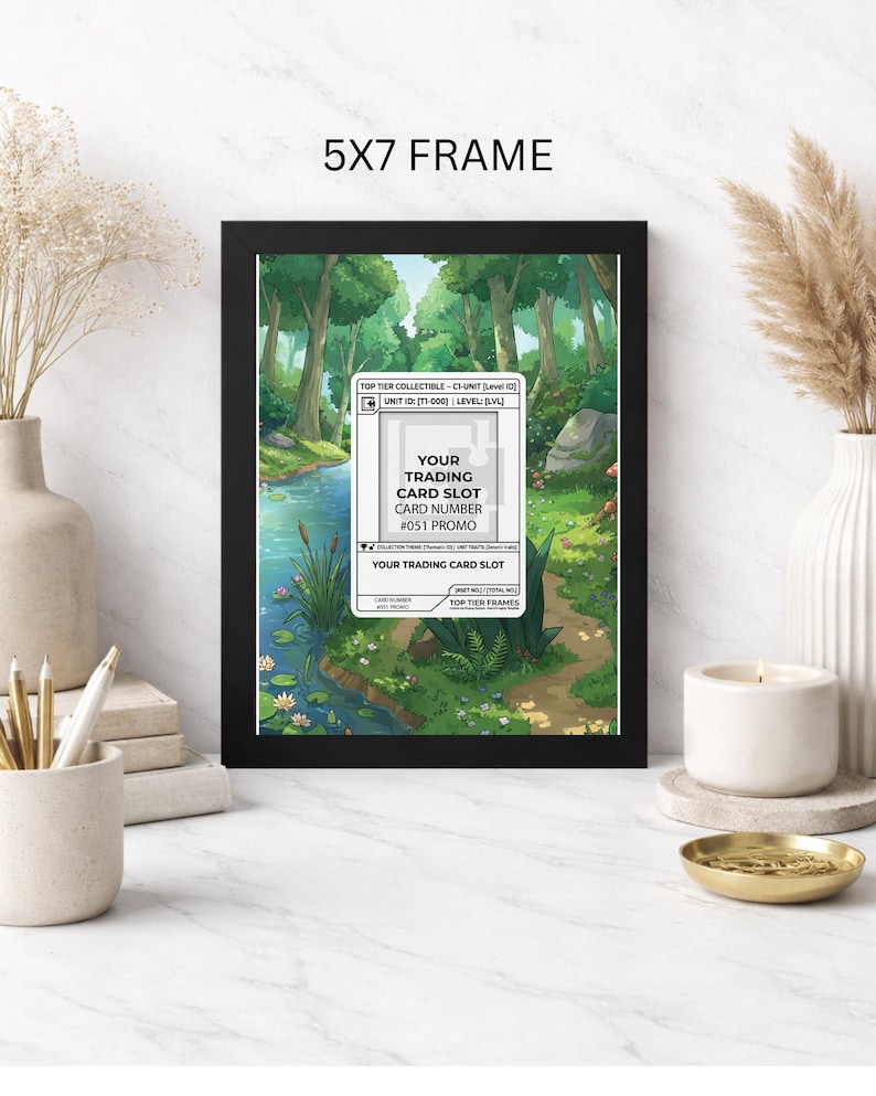 May include: A black 5x7 frame displays a colorful illustration of a forest scene with a river and a path. The frame holds a trading card slot with text that reads "YOUR TRADING CARD SLOT" and "#051 PROMO".