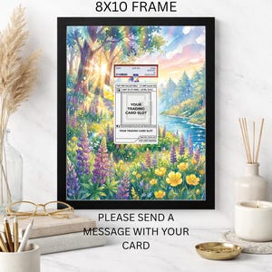 May include: A black 8x10 frame displaying a custom trading card design. The artwork is a watercolour landscape with a river, trees, and flowers. Text on the frame reads "CUSTOM DESIGN FOR YOUR CARD" and "PLEASE SEND A MESSAGE WITH YOUR CARD."